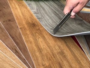 guy cutting showing durability of vinyl flooring 