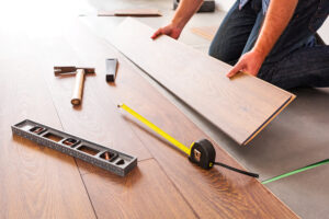 man installing laminated hardwood floors